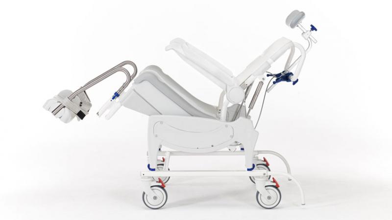 Detail of the tilt-in-space mechanism on the Invacare Aquatec Ocean VIP Ergo Shower Commode demonstrating its range of motion.