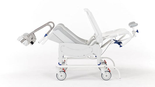 Side profile of the Invacare Aquatec Ocean VIP Ergo Tilt-in-Space Shower Commode showcasing adjustable footrests and armrests.