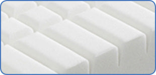 Close-up of white mattress topper with blue border