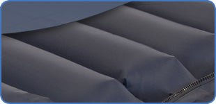 Side view of Apollo 5 Premium overlay mattress showing 18-cell air structure with hose connected