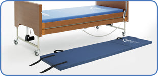 Deployed crash mattress alongside a profiling bed for fall protection