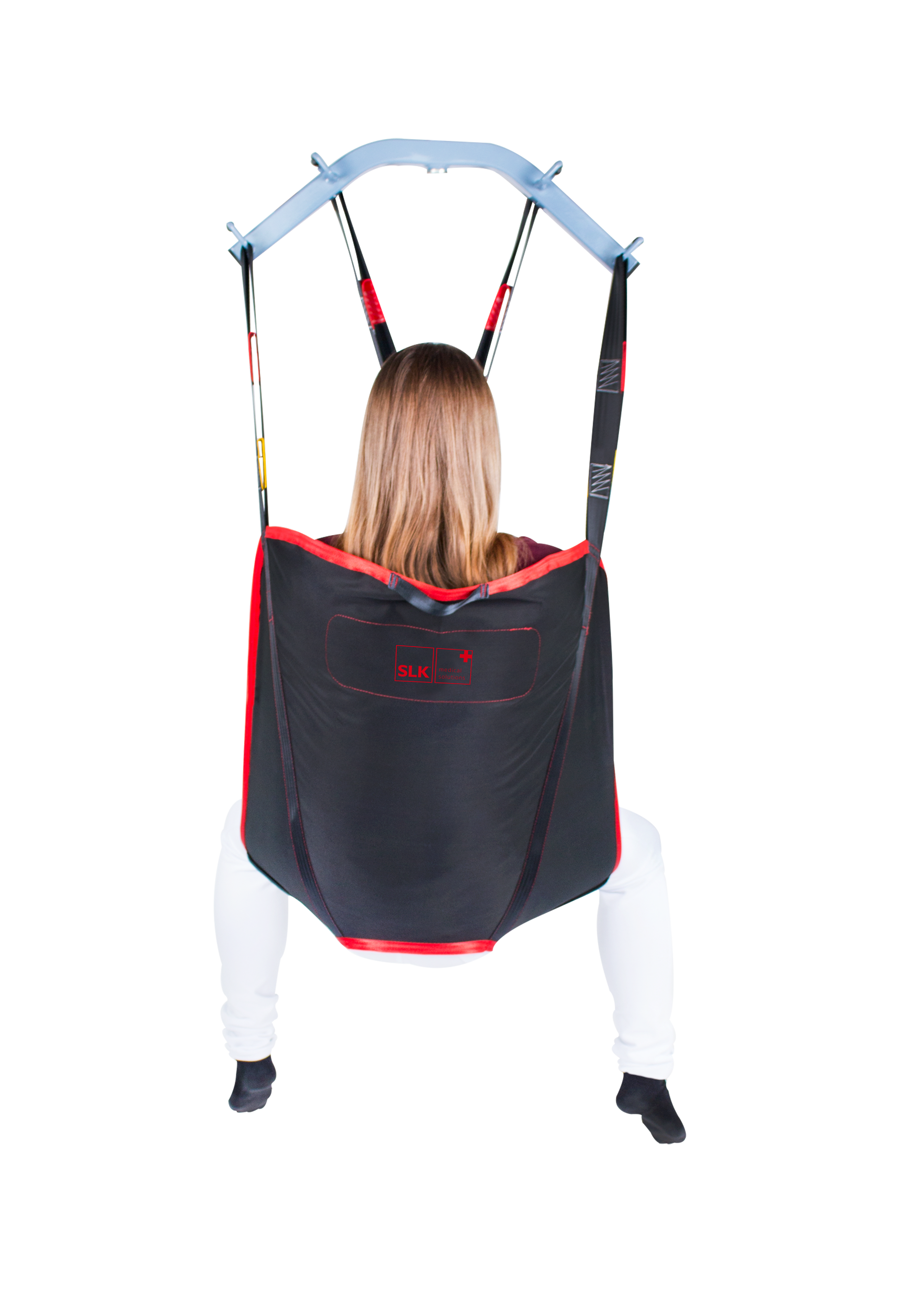 SLK Universal Sling in use with a patient, demonstrating full-body support during a transfer.