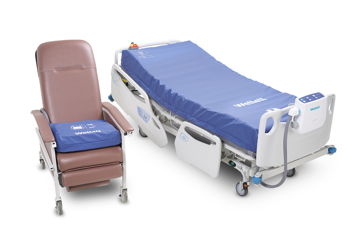 Procare Auto G3 mattress in clinical setting with caregiver adjusting controls, highlighting its integration in patient care