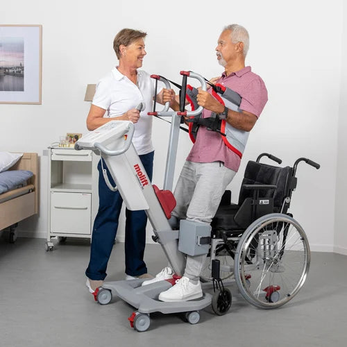 Molift Quick Raiser 205 in use – caregiver assisting patient from seated to standing position using the ergonomic lift.