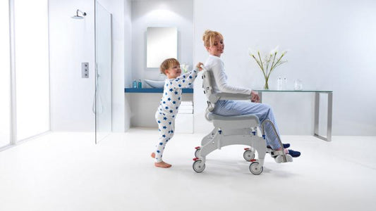 “Aquatec Ocean Ergo shower chair positioned in tiled bathroom for mobility and hygiene support
