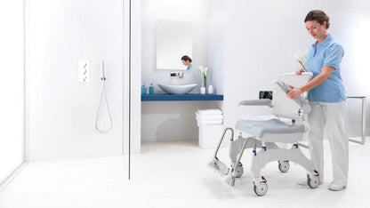 Aquatec Ocean Ergo shower chair positioned in tiled bathroom for mobility and hygiene support