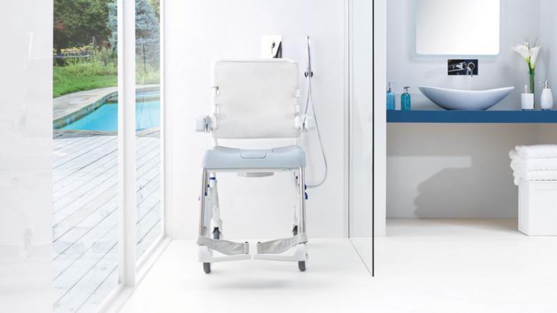 “Aquatec Ocean Ergo shower chair positioned in tiled bathroom for mobility and hygiene support