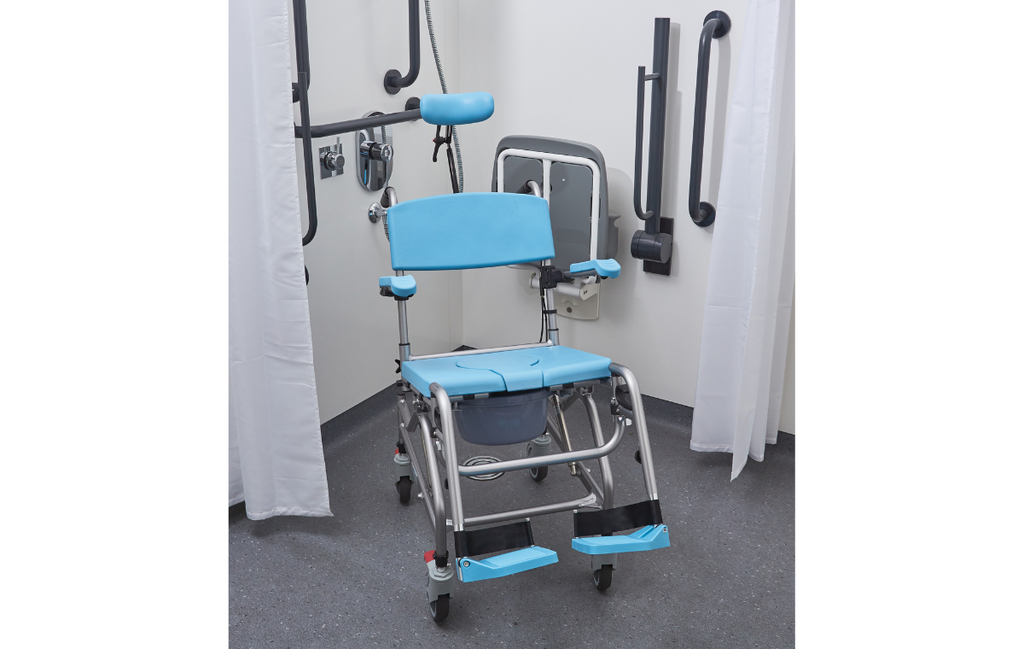 Alerta Aqua Community Tilt‑in‑Space Shower Commode Chair front view in a care home bathroom