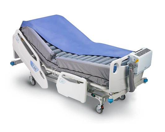 Wellell ACS Turn mattress installed on a profiling bed with raised safety bolsters.
