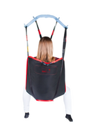 SLK Universal Sling in use with a patient, demonstrating full-body support during a transfer.