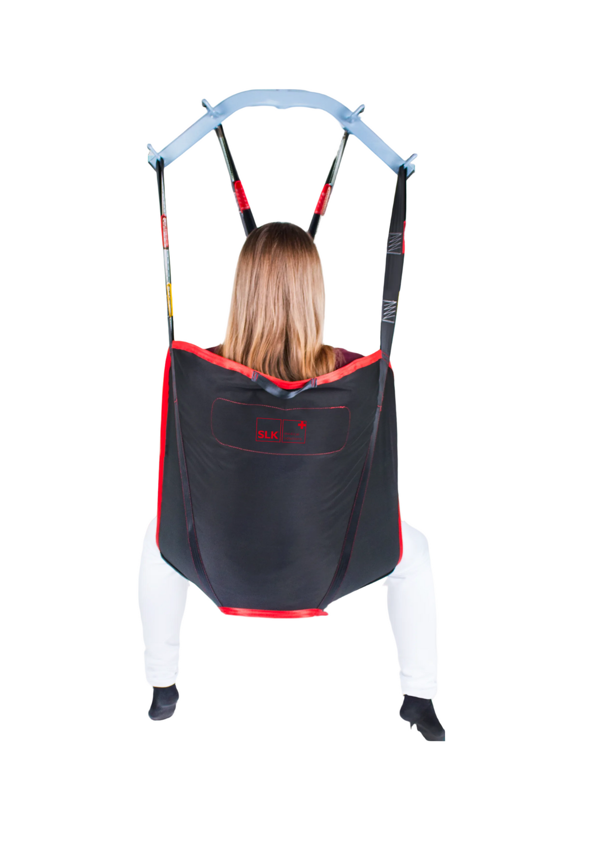 SLK Universal Sling in use with a patient, demonstrating full-body support during a transfer.