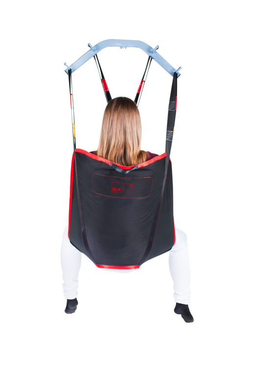 SLK Universal Sling in use with a patient, demonstrating full-body support during a transfer.
