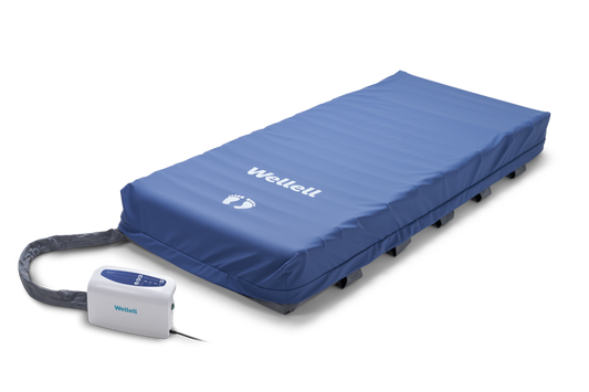 Heel relief zone with adjustable air cells for targeted pressure offloading.