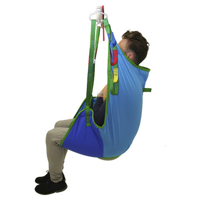 A full view of a blue Harvest Universal Deluxe sling. Showing how it is used with a service user inside the sling and hooked up to a spreader bar.