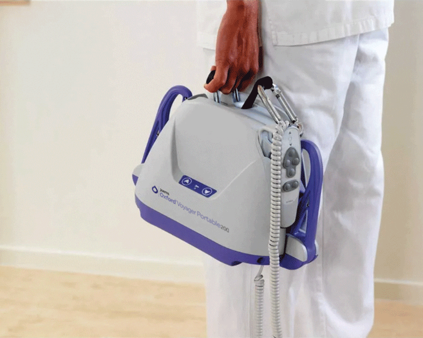 Oxford Voyager Portable Hoist being carried by a carer
