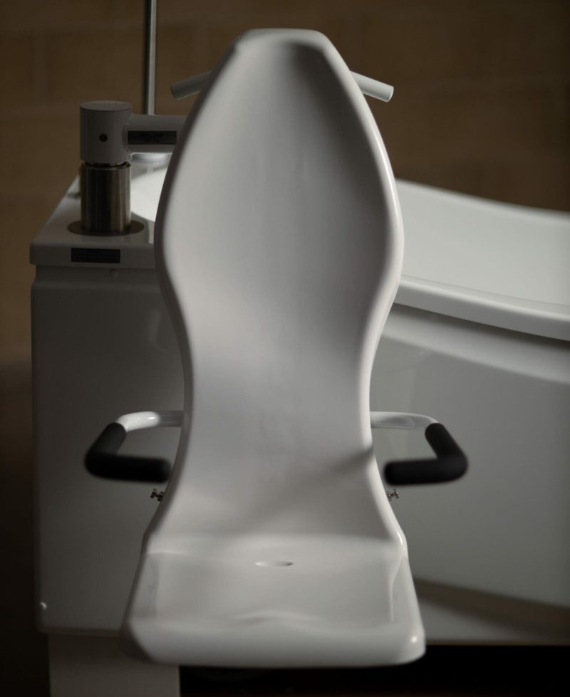 Astor Compact Plus assisted bath with tilt and spa options. Seat close up.