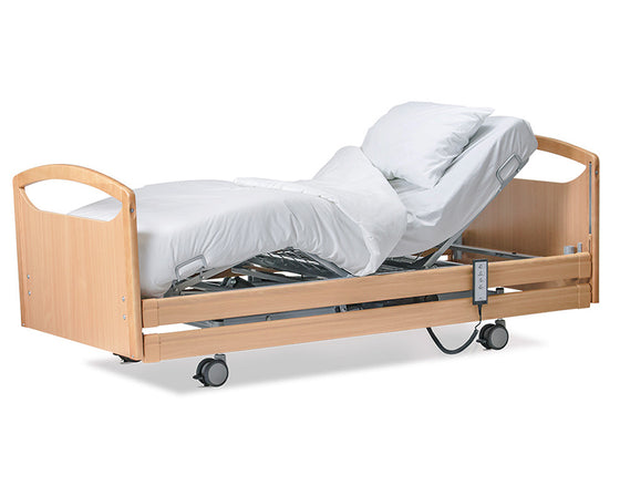 Wellell Pro-Care Wide Community Profiling Bed with beech timber siderails. Showing the head and leg rising feature.