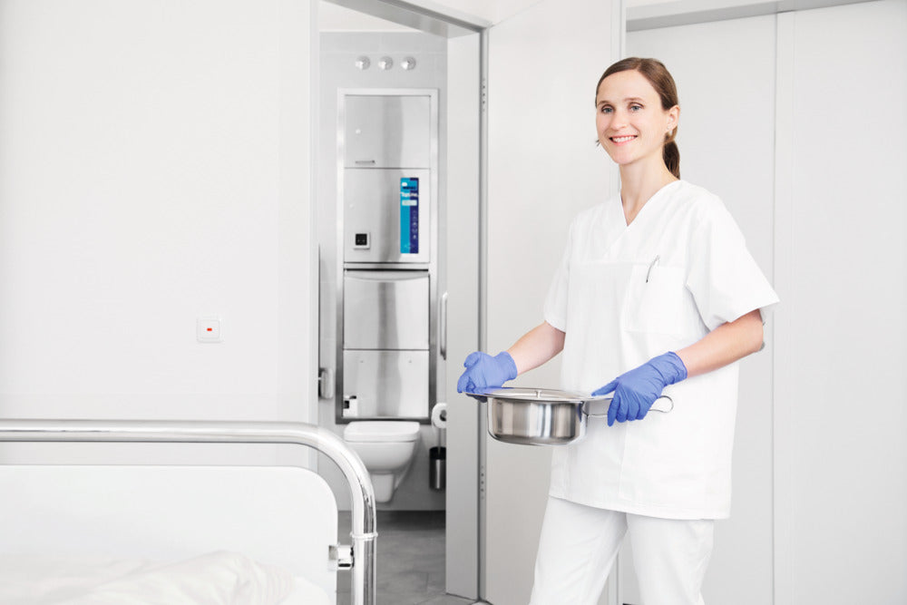Meiko TopLine 30 freestanding washer-disinfector for care environments. Showing clean equipment after being washed.