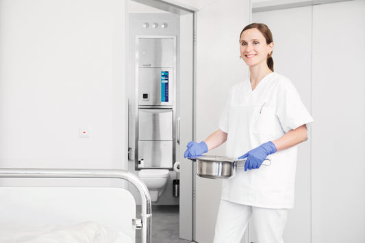 Meiko TopLine 30 freestanding washer-disinfector for care environments. Showing clean equipment after being washed.