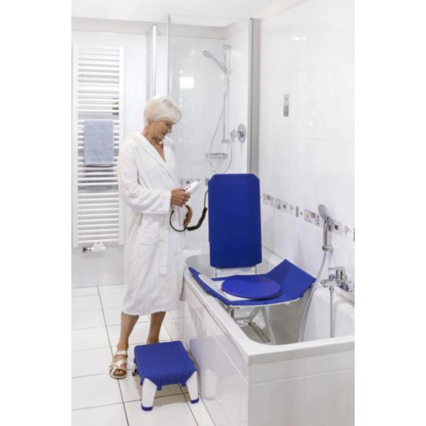 Invacare Orca bath lift shown fully reclined in white bathtub for safe and comfortable bathing