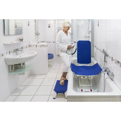 Elderly user seated on Invacare Orca bath lift demonstrating comfort and safety in use