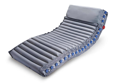 Optima Prone prone-position mattress fitted on a hospital bed, showing the full alternating air cell surface and shoulder-lift section.