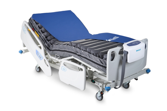 Wellell Pro-Care Auto alternating pressure mattress system displayed on a hospital bed.