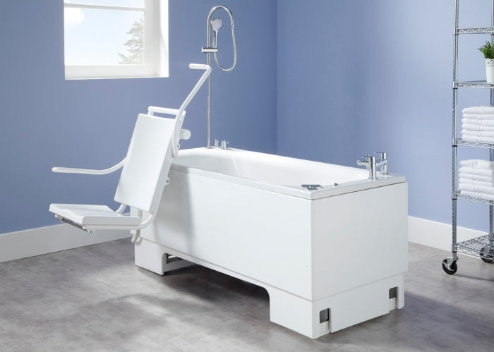 Excel 600 height adjustable bath front view with powered swing seat in care home setting