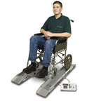 Patient in wheelchair on Marsden M-610 weigh beams with digital indicator